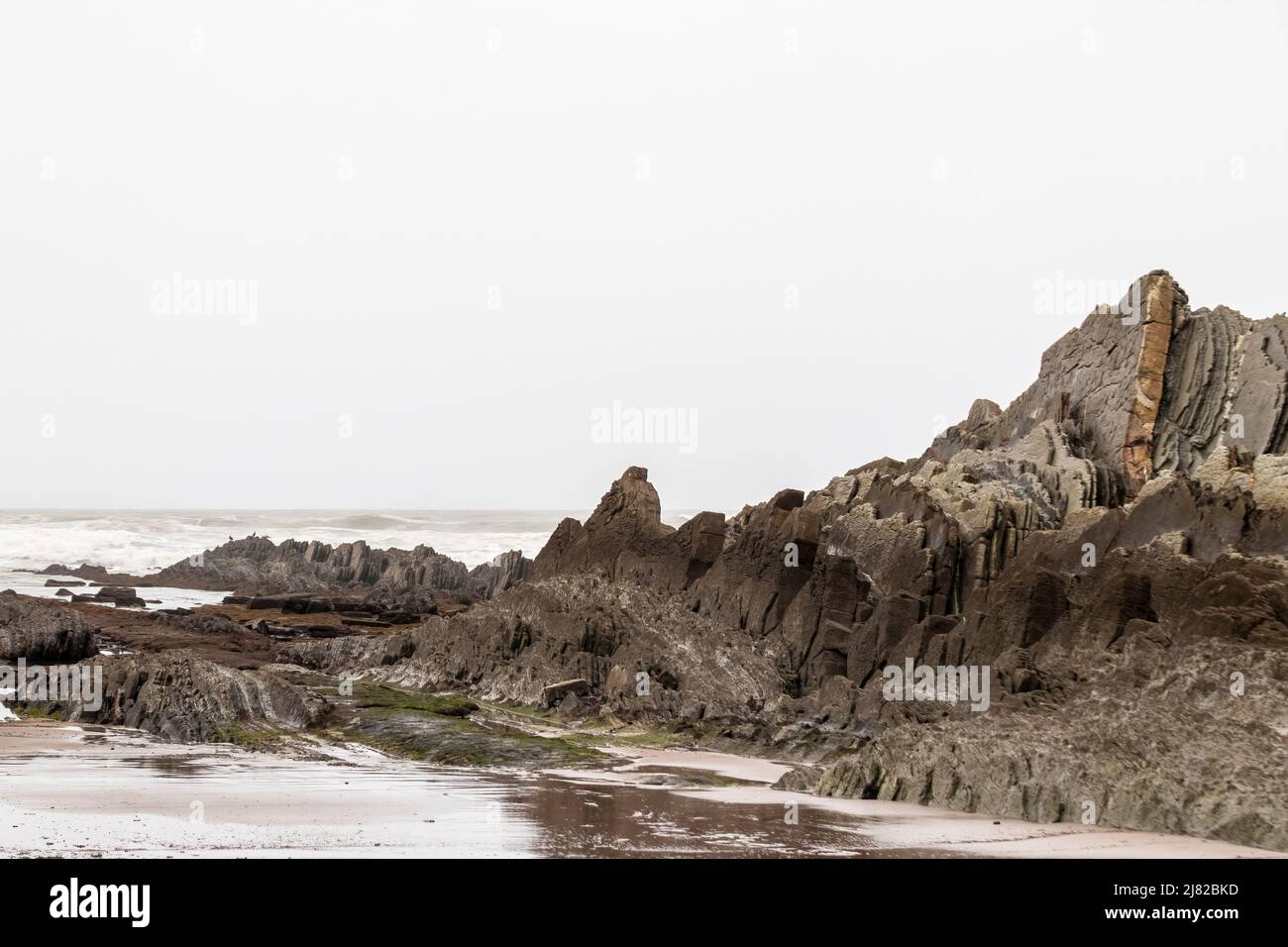 rocks on the beaches of sopelana in the cantabrian sea a cloudy day Stock Photo