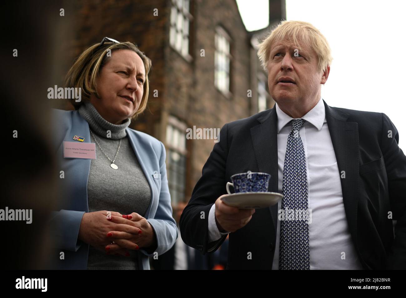 International Trade Secretary Anne-Marie Trevelyan and Prime Minister Boris Johnson talk to local business people after a regional cabinet meeting at Middleport Pottery in Stoke on Trent. Picture date: Thursday May 12, 2022. Stock Photo