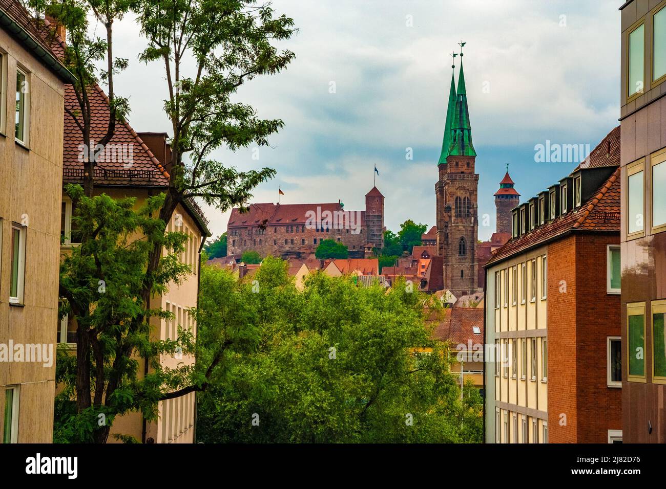 The Imperial castle (Kaiserburg) with Heathens' Tower (Heidenturm) and Sinwell Tower (Sinwellturm) on the ridge in Nuremberg. In front are the two... Stock Photo