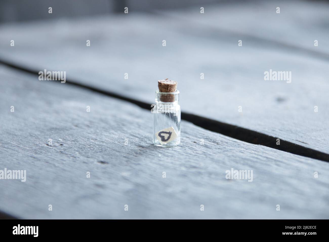 Valentines Day vintage background. Small bottle with a heart. Stock Photo