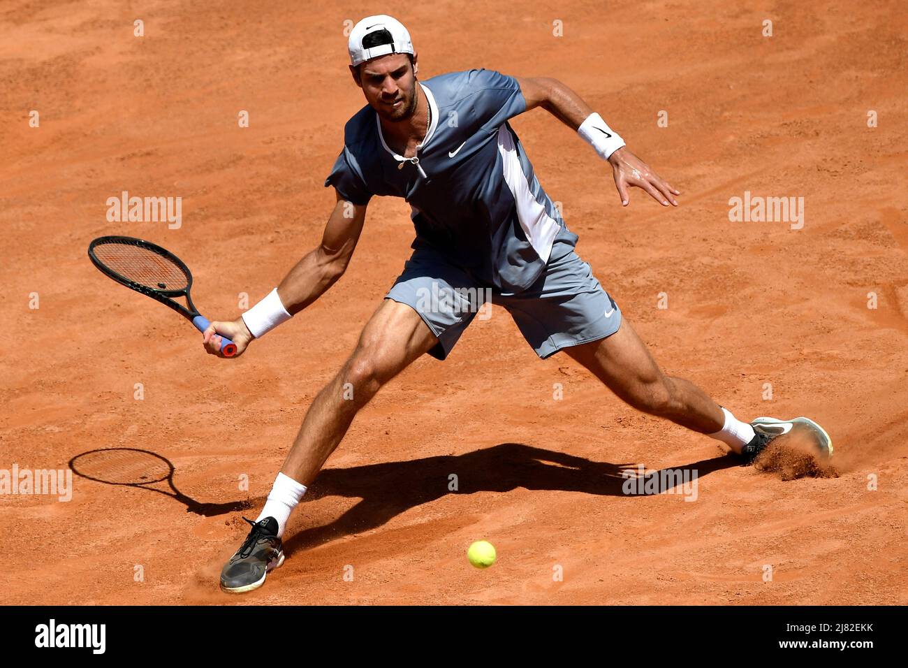 Rome, Italy. 12th May, 2022. Karen Khachanov of Russia returns to Stefanos  Tsitsipas of Greece during their round of 16 match at the Internazionali BNL  D'Italia tennis tournament at Foro Italico in
