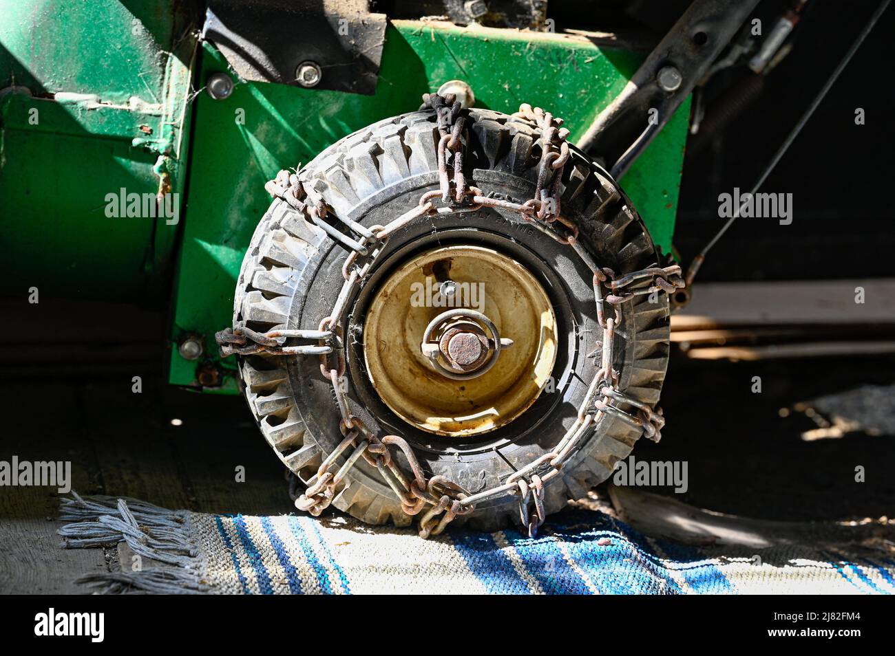Tire with snow chains on snow thrower Stock Photo