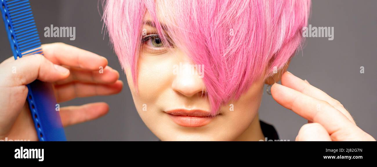Hairdresser with hands and comb is checking out and fixing the short