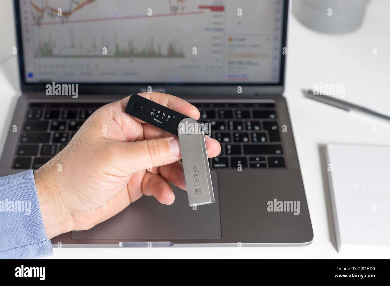 Russia, Krasnodar - April 15, 2022: Hand holding hardware cryptocurrency  wallet Ledger on laptop background. Safe storage for crypto. closeup Stock  Photo - Alamy