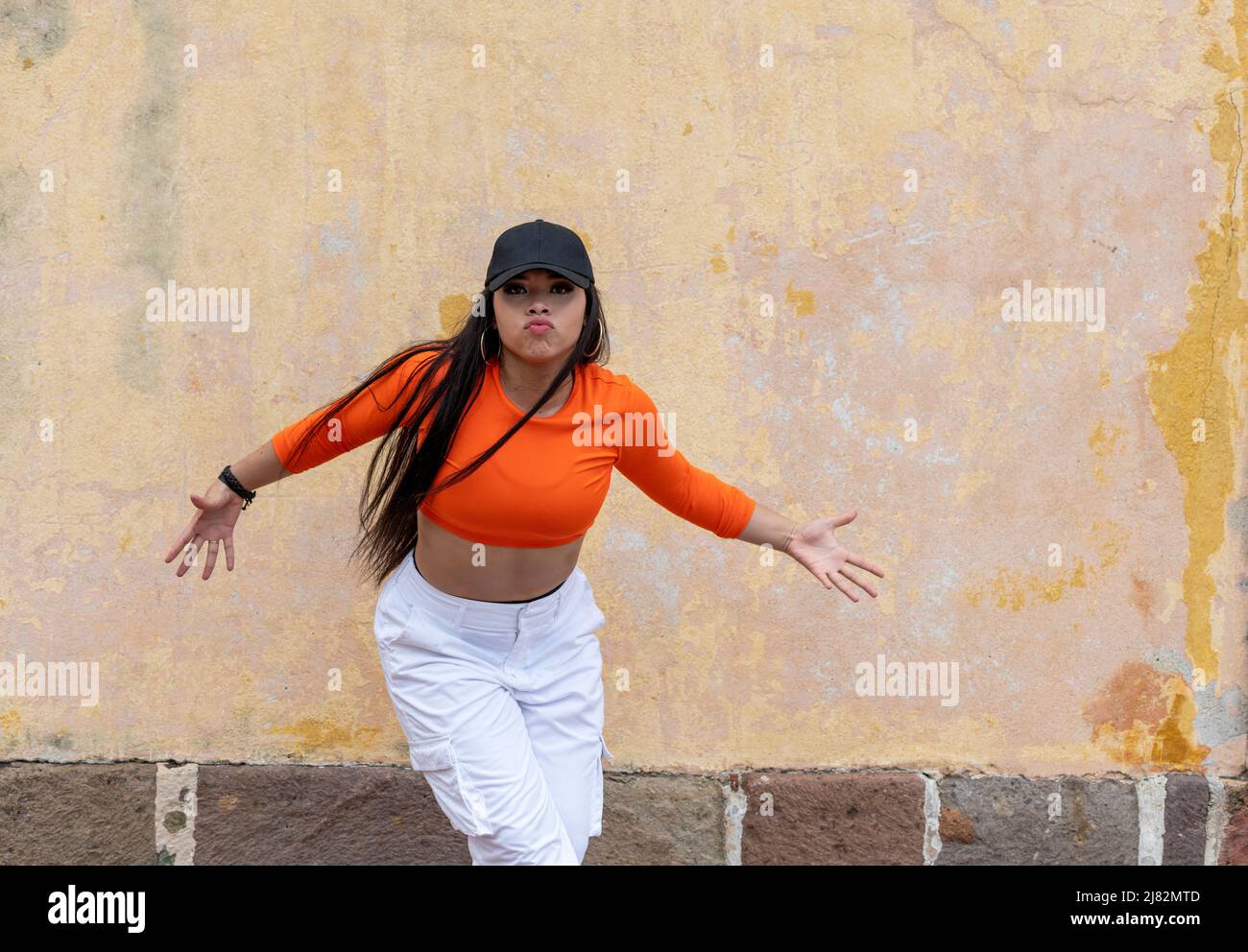 Funky young latin woman hip hop dancing in the street, Panama - stock photo Stock Photo