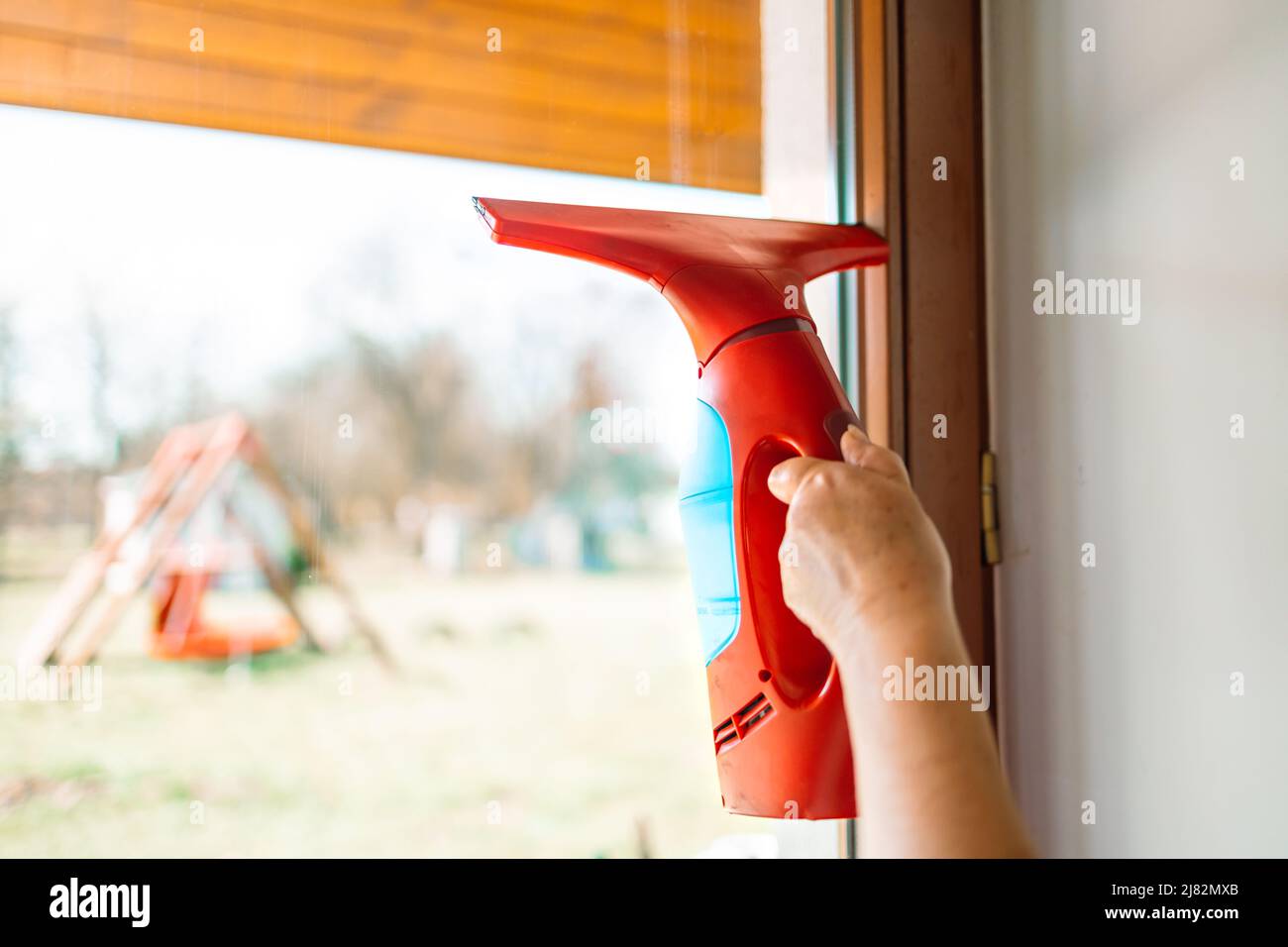 Cleaning windows with portable professional vacuum cleaner Stock Photo