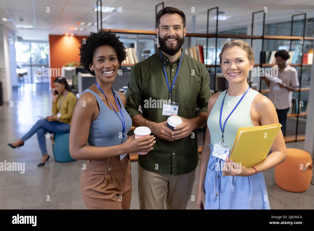 Portrait of happy multiracial colleagues in modern workplace Stock ...