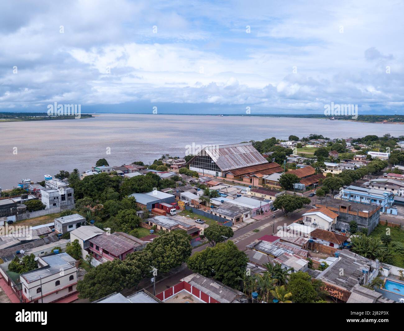 Beautiful drone aerial view of Amazonas river and Itacoatiara city skyline in the Amazon rainforest, Brazil. Environment, ecology, cityscape concept. Stock Photo