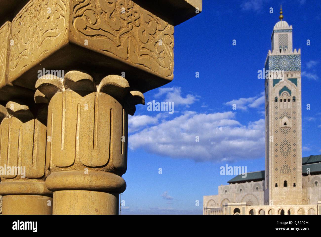 columns with arab patterns and mosque Hassan II in the background, Casablanca Morocco Stock Photo