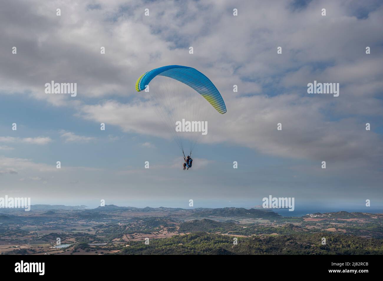 First flight with a tandem paragliding instructor. Photo taken from the El Toro lookout point, municipality of Es Mercadal, Menorca, Spain Stock Photo