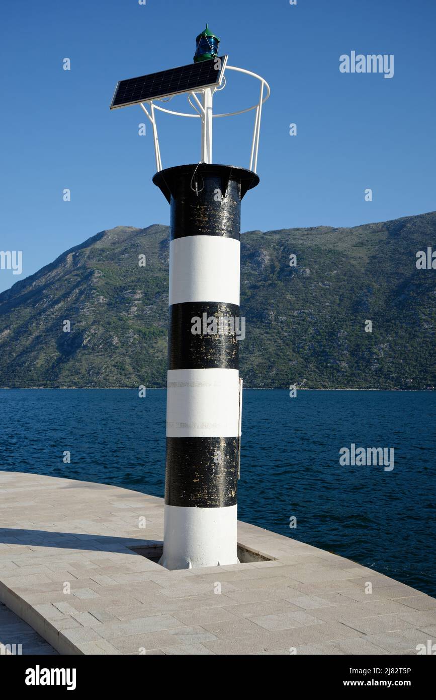 A small lighthouse tower by the sea. Stock Photo