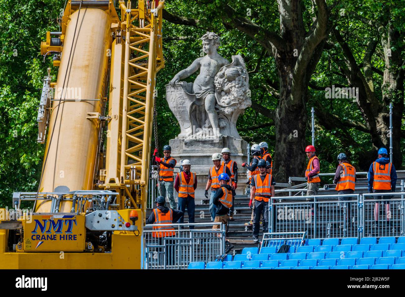 London, UK. 12th May, 2022. Grandstands are constructed around the flags that surround the Victoria Monument, outside Buckingham Palace, for the audiences for the weekend parties/events to come. Preparations for the celebration of the Platinum Jubilee of HM The Queen Elizabeth. Credit: Guy Bell/Alamy Live News Stock Photo