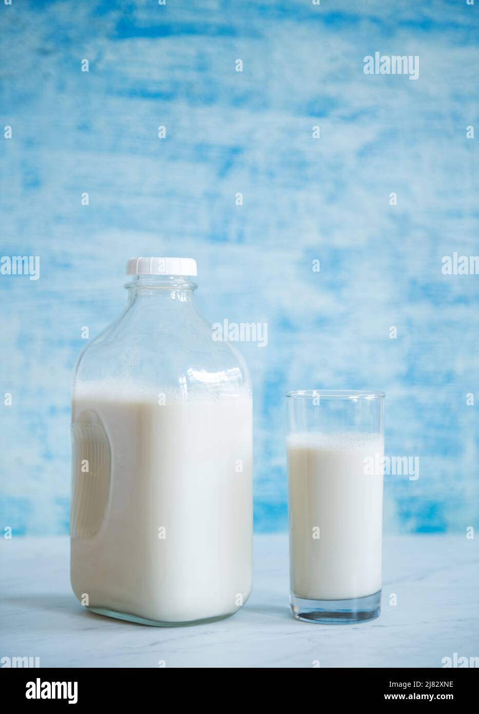 Jug of milk with glass of milk Stock Photo Alamy