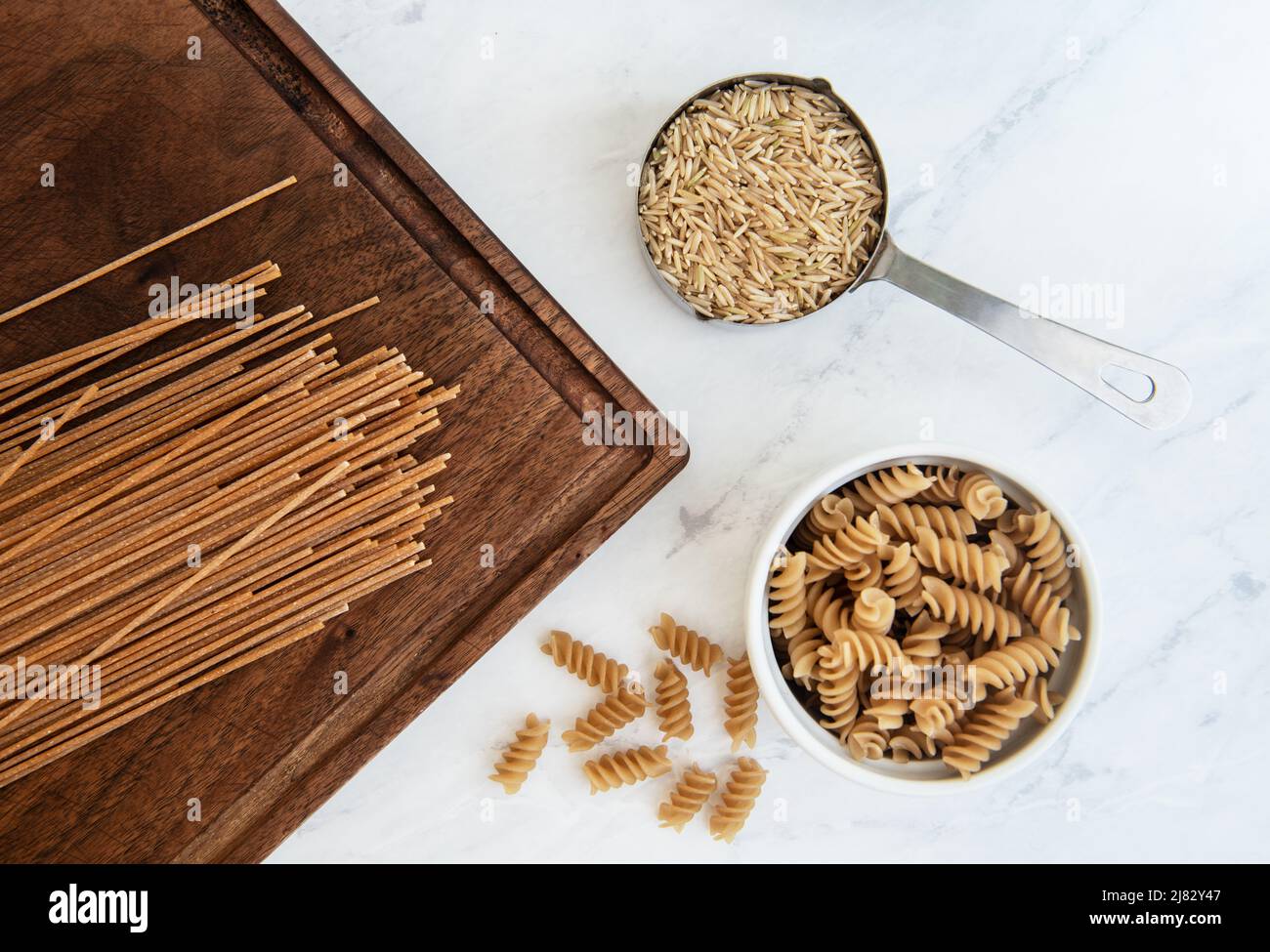 Healthy grains of brown rice, and whole wheat pasta Stock Photo Alamy