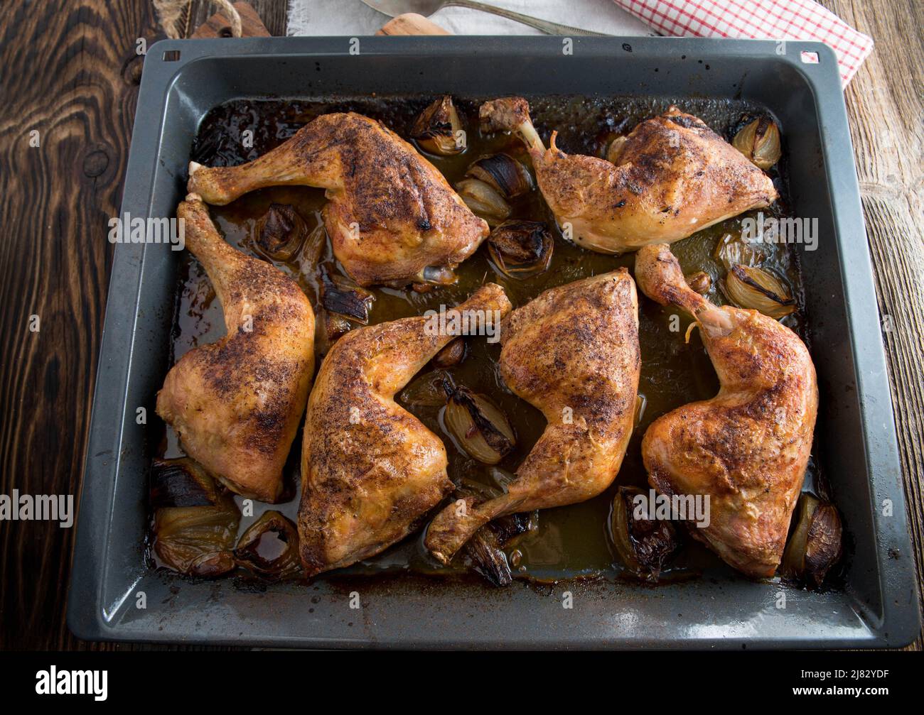Oven baked Chicken legs on a baking tray Stock Photo
