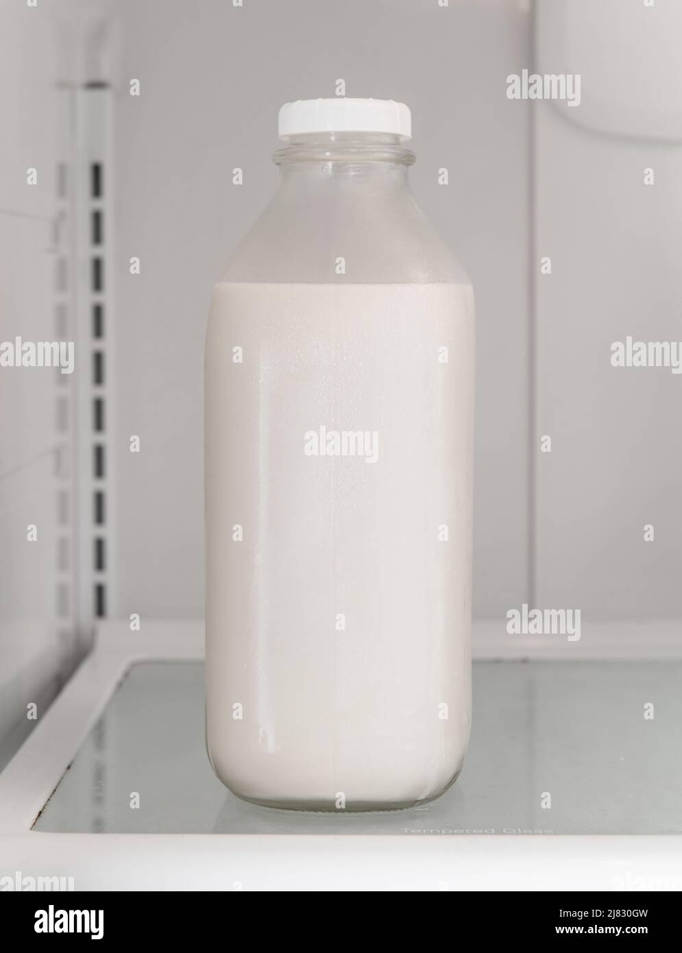 Bottle of milk in the fridge Stock Photo Alamy