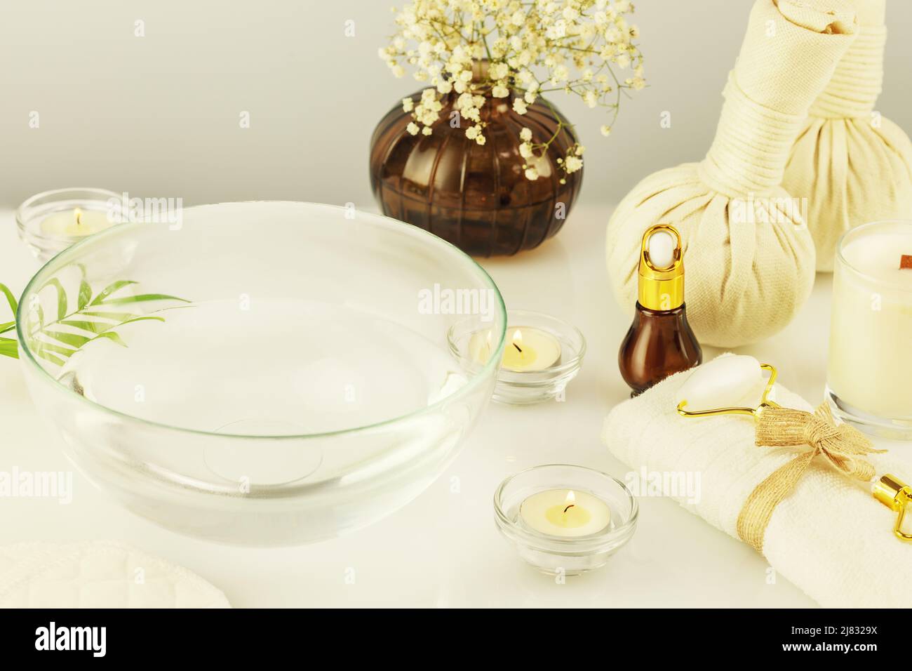 Beauty salon life stile with cosmetology products, spa accessories and candles. Spa relax composition. Preparing for facial care procedure. Concept of Stock Photo