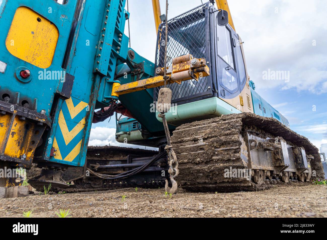 mechanical hammer of a pile driver standing on a technological surface, selective focus Stock Photo