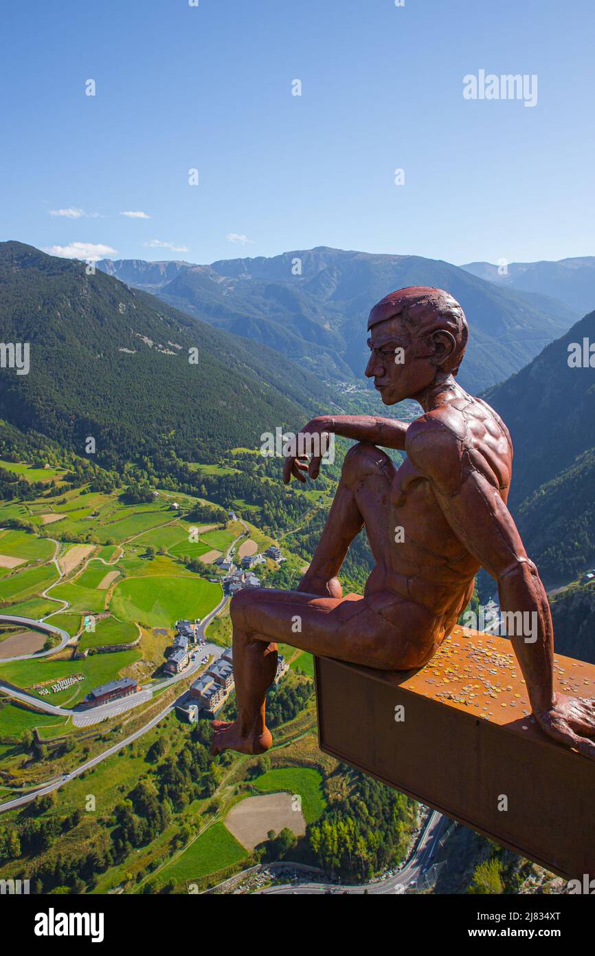 Bronze Statue of a man sitting in the famous viewpoint of 'Roc del Quer' during a sunny spring day in Andorra Stock Photo