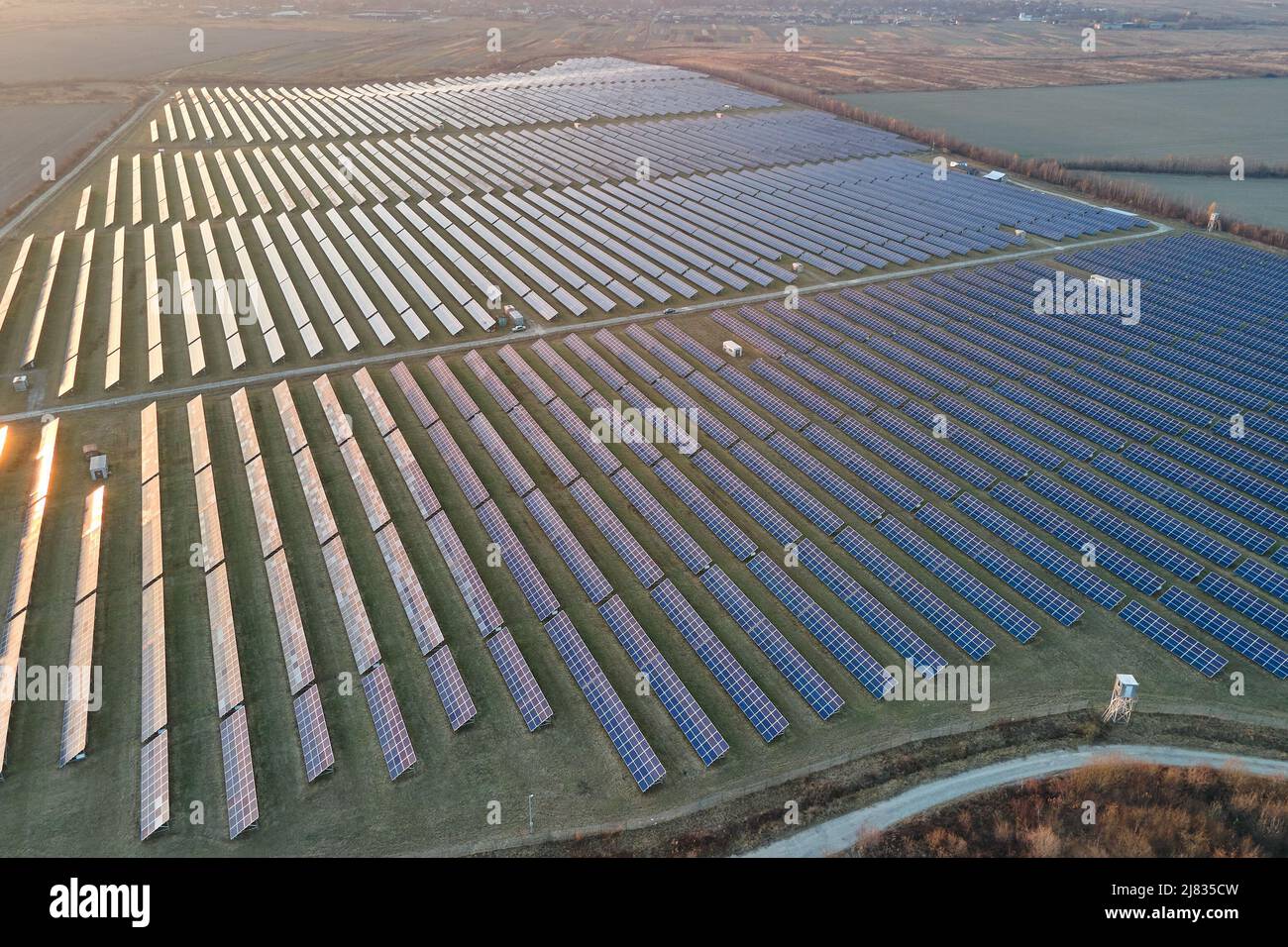 Aerial view of big sustainable electric power plant with many rows of
