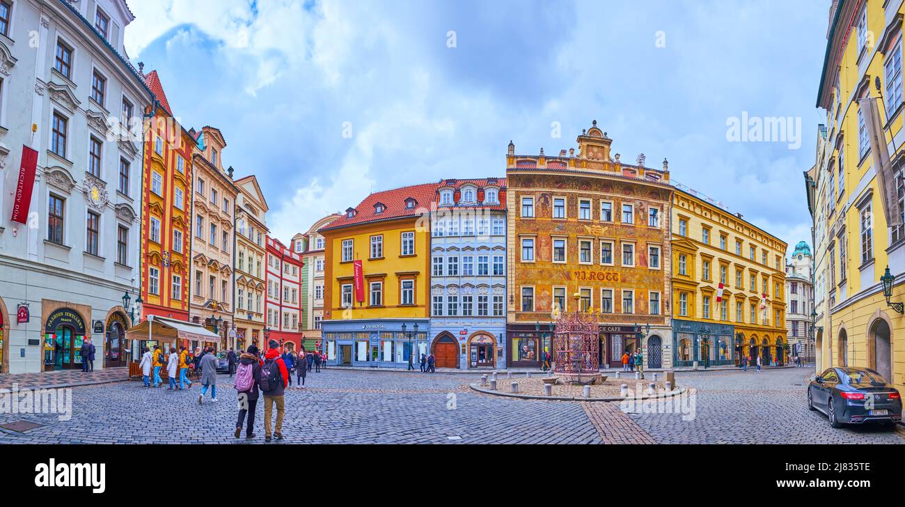 PRAGUE, CZECH REPUBLIC - MARCH 5, 2022: Panorama of the Little Square with small fountain, townhouses and colorful ornaments of U Rotta House, on Marc Stock Photo