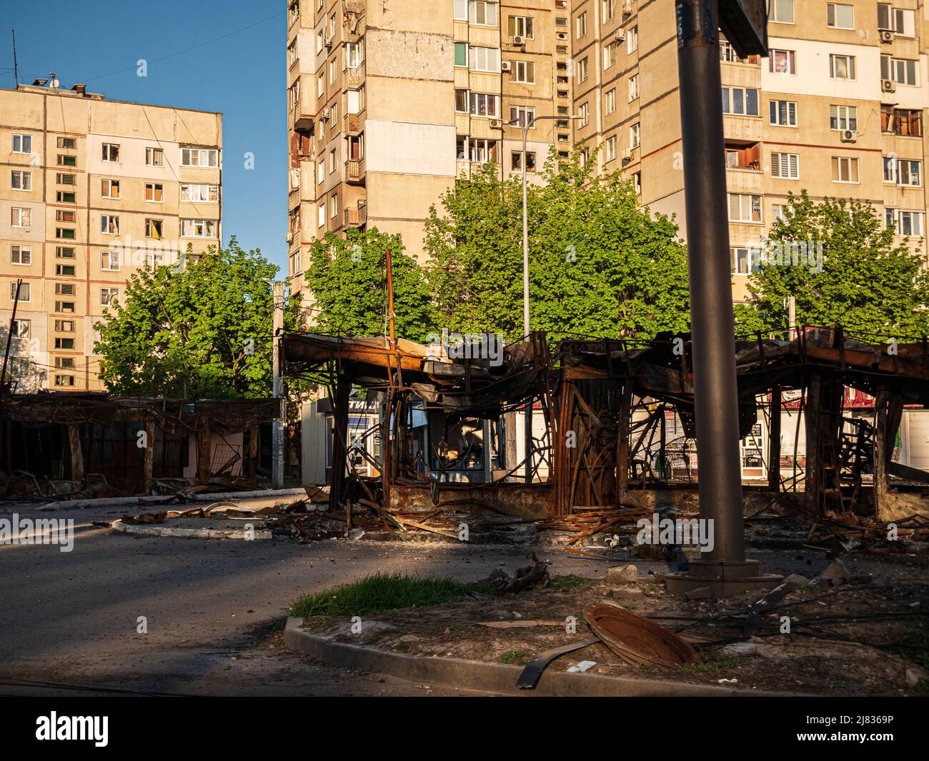 Kharkiv, Kharkov, Ukraine - 05.07.2022: burnt destroyed car wash shop gas station metal construction wreckage ruins on street after bombing civilian Stock Photo