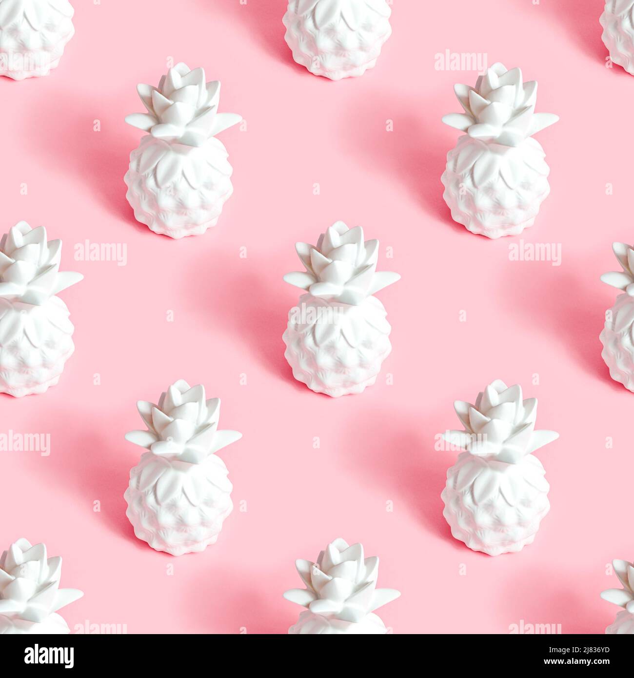 White pineapple tropical fruit repeat seamless pattern on light pastel pink background for wrapping paper. Stock Photo