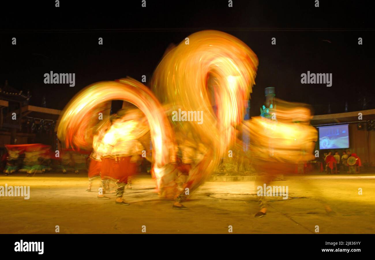 Fenghuang, Hunan Province, China: Dragon dance at a night festival in Fenghuang. The Chinese dragon dance is a traditional cultural performance. Stock Photo