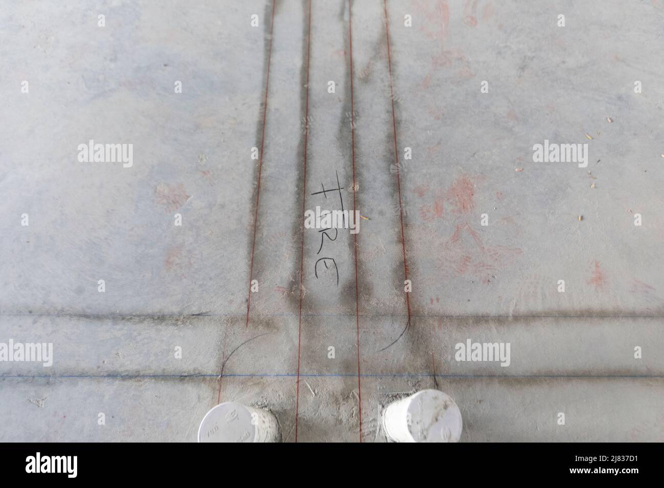 Concrete Slab outlined for metal framing with division wall between two