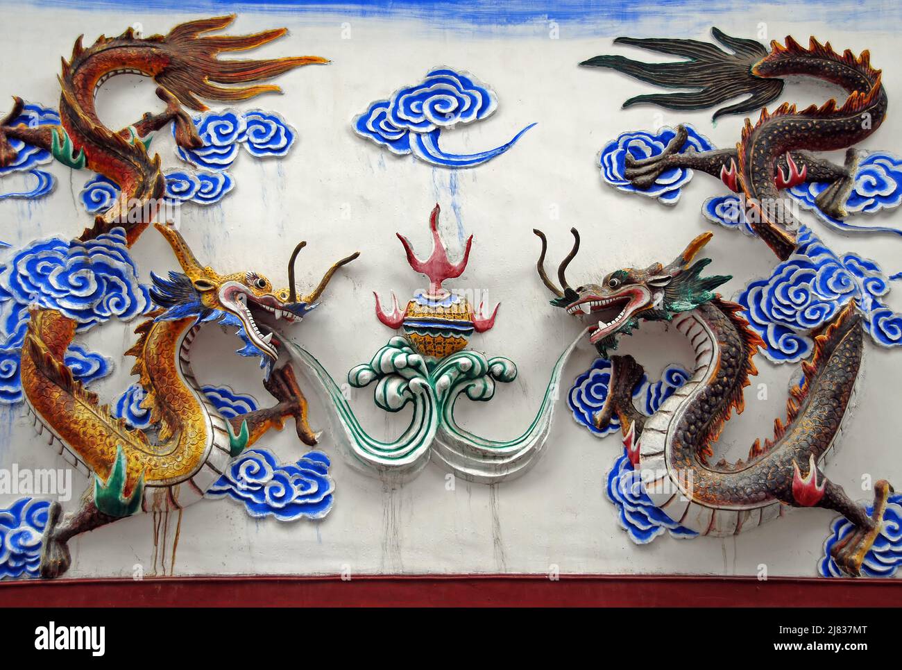 Fenghuang, Hunan Province, China: A dragon screen in Fenghuang showing two colorful dragons. Traditional Chinese art. Stock Photo