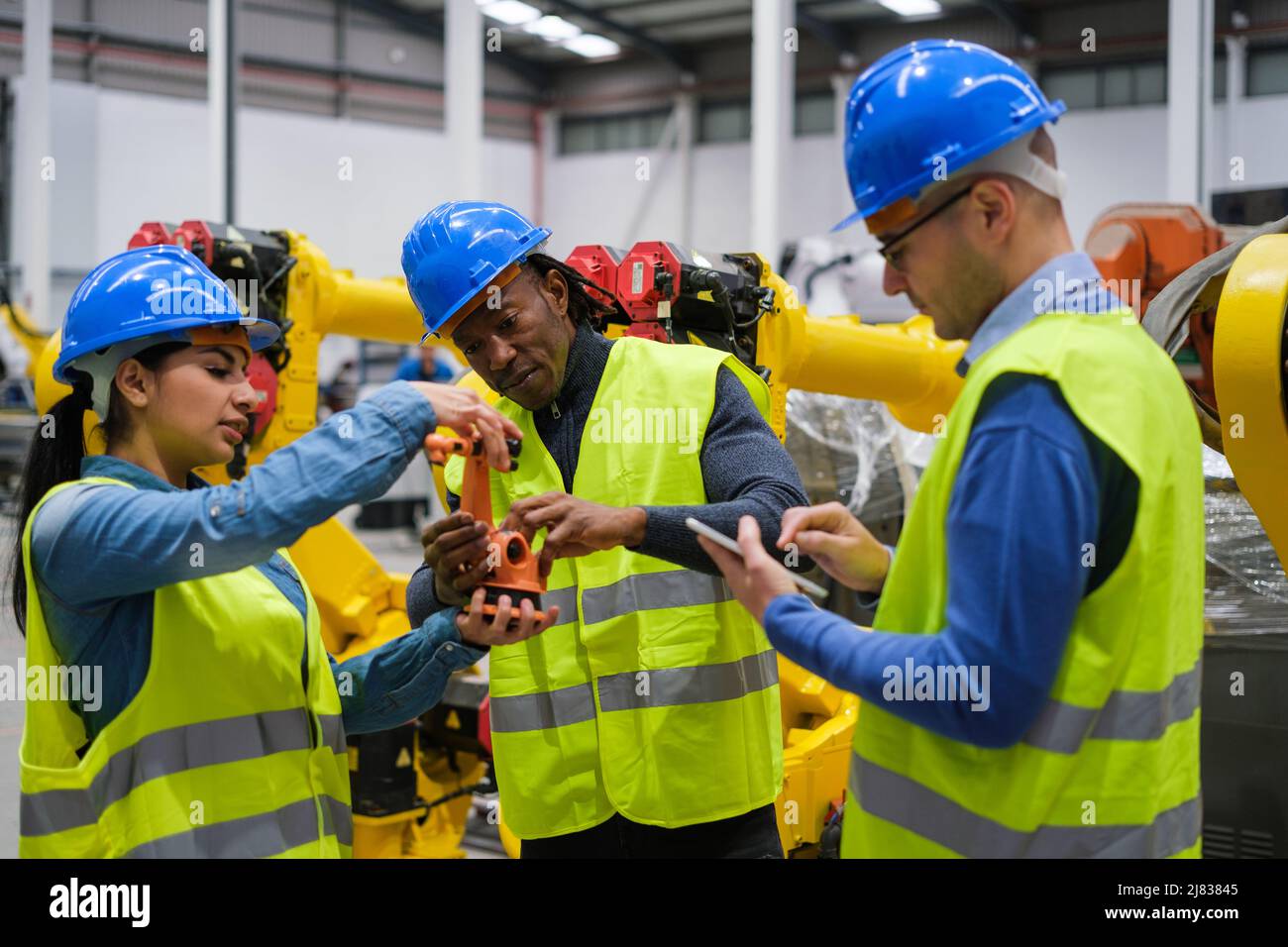 Group of engineers working on the functioning of machines Stock Photo