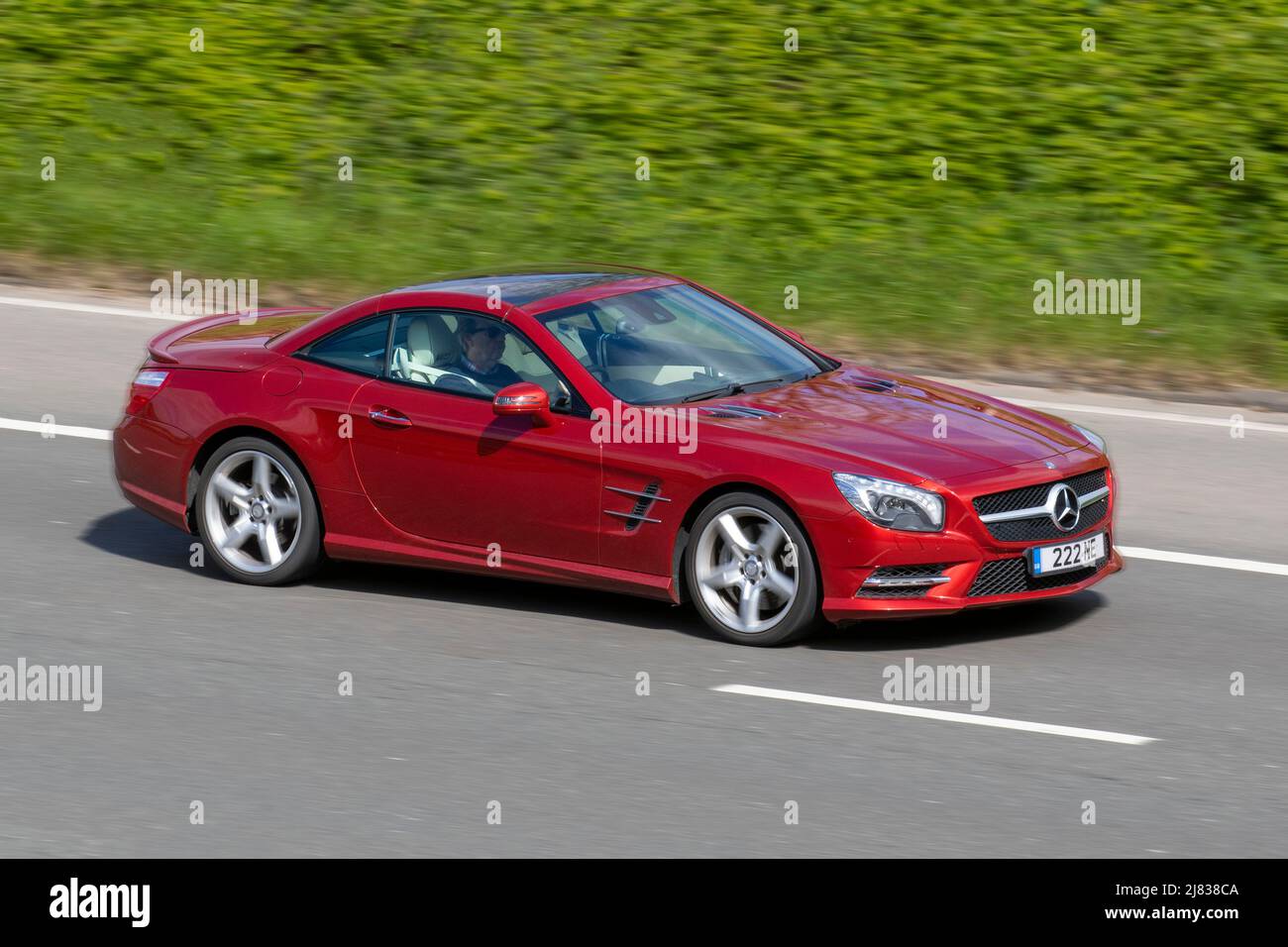 2015 red Mercedes Benz SL400 Amg Sport 7G-Tronic Auto 2996cc petrol coupe; driving on the M6 motorway, UK Stock Photo