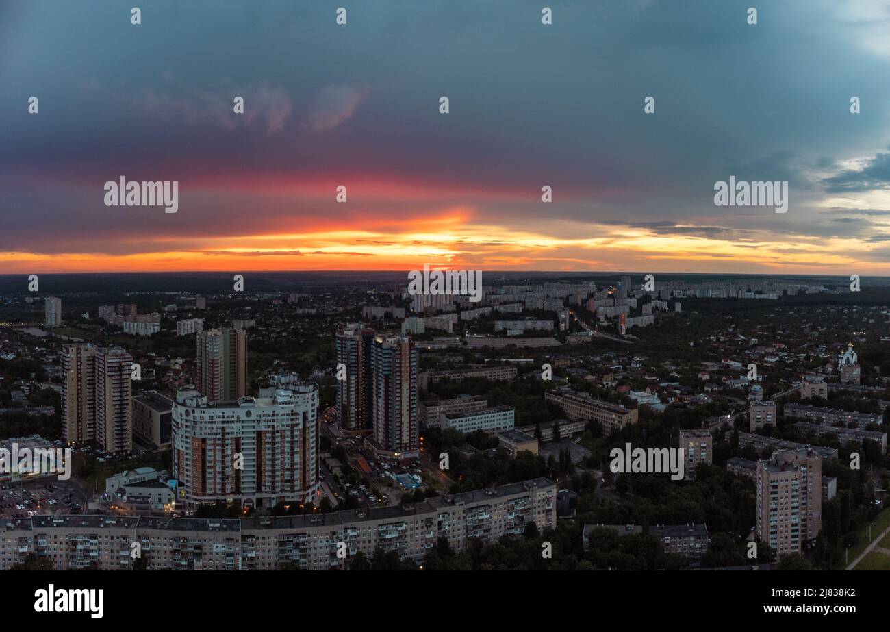 Epic vibrant sunset aerial view in city residential multistory district. 23 serpnia, Pavlovo Pole, Kharkiv, Ukraine. Fly at dusk, evening cloudscape a Stock Photo