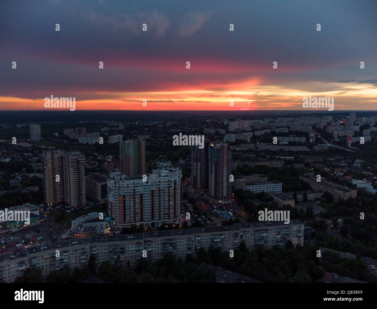 Vibrant sunset aerial view in city modern residential multistory district. 23 serpnia, Pavlovo Pole, Kharkiv, Ukraine. Fly at dusk, evening cloudscape Stock Photo