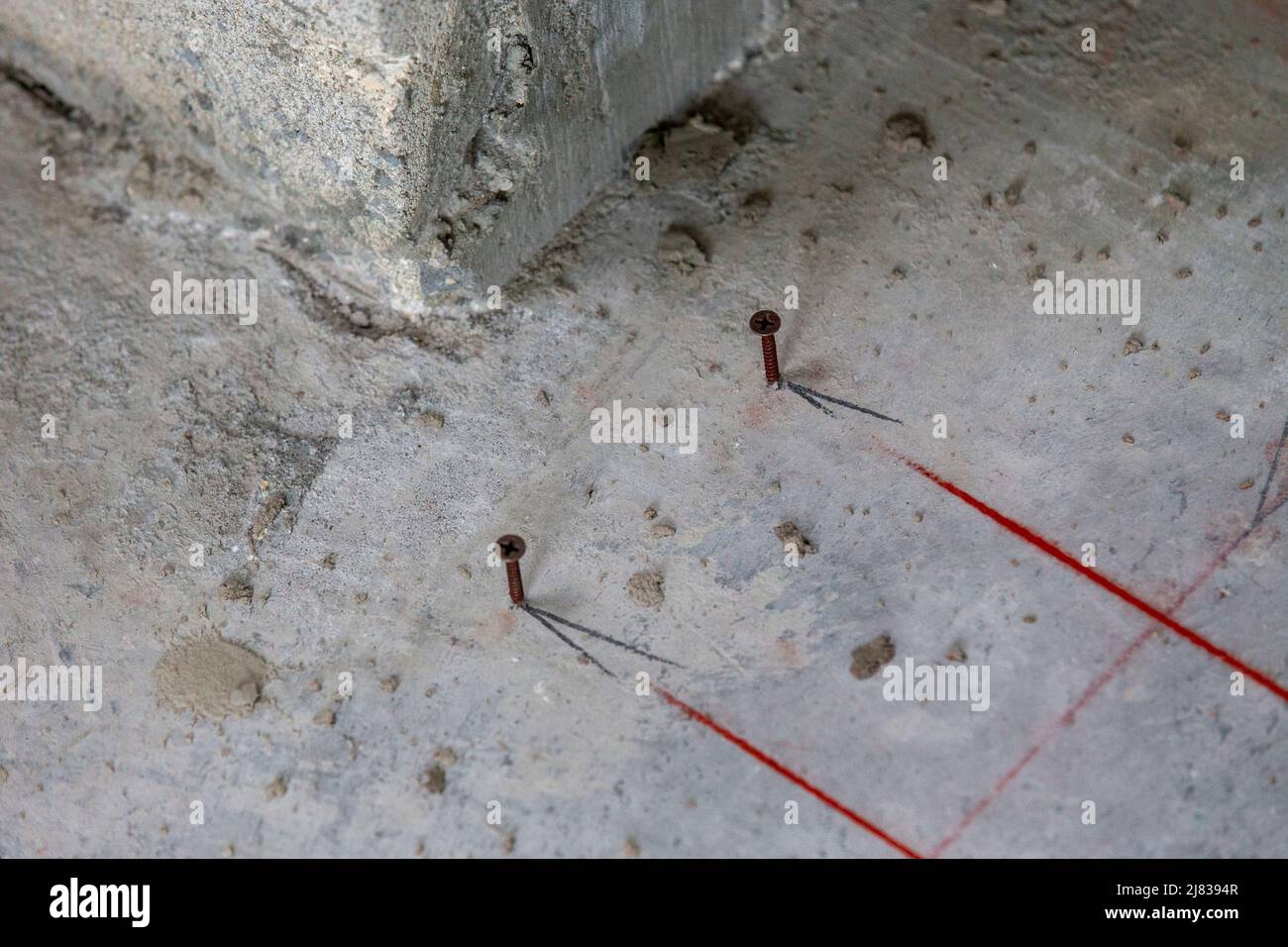 screws hammered into concrete used to start the outlining for floorpan