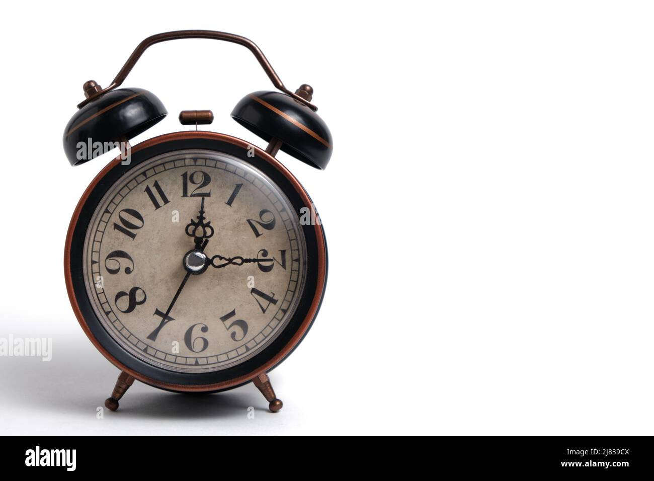 Old retro alarm clock in brown on white background Stock Photo
