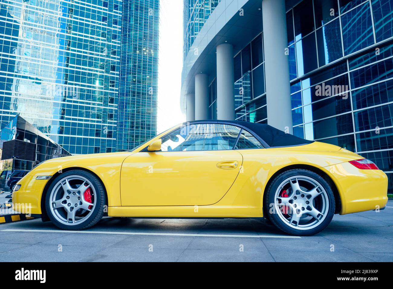 Yellow sport car on the background of the business center Stock Photo