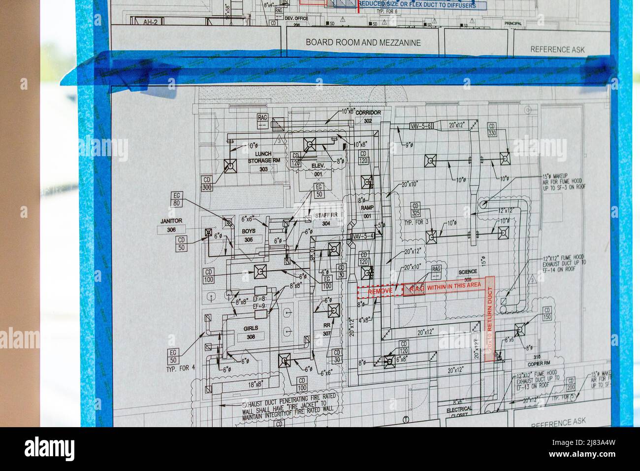 Blueprint for a commercial building taped to a window Stock Photo