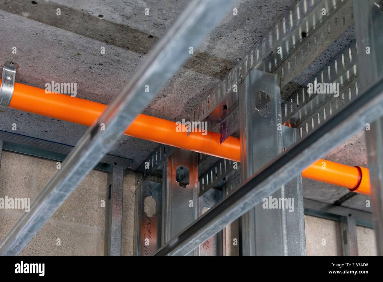 Orange Fire Sprinkler Pipes above freshly installed galvanized steel