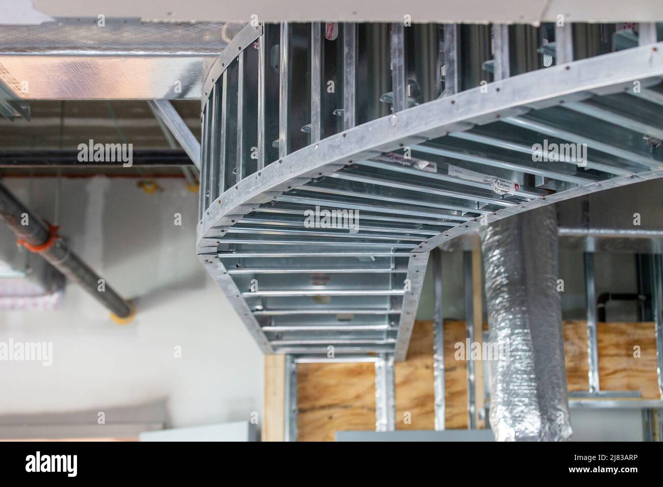 Galvanized Steel structure framing with overhead curve, ready for drywall installation Stock Photo