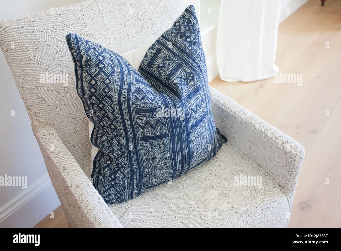 Serene Contrast: The Blue Cushion on White Stock Photo