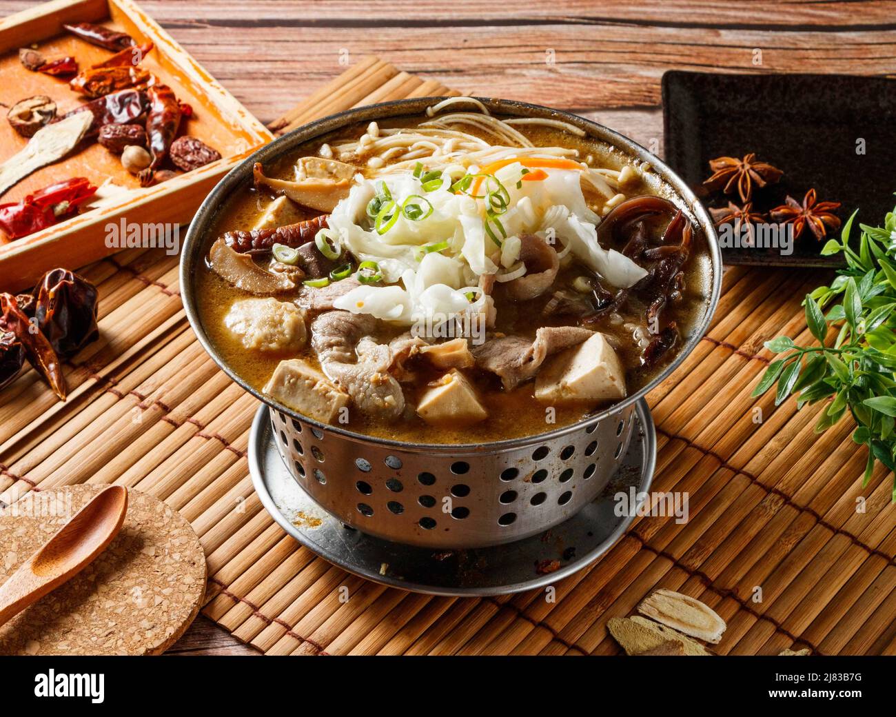 Stinky Lamb hot pot stew with red chili isolated on mat side view of japanese food Stock Photo