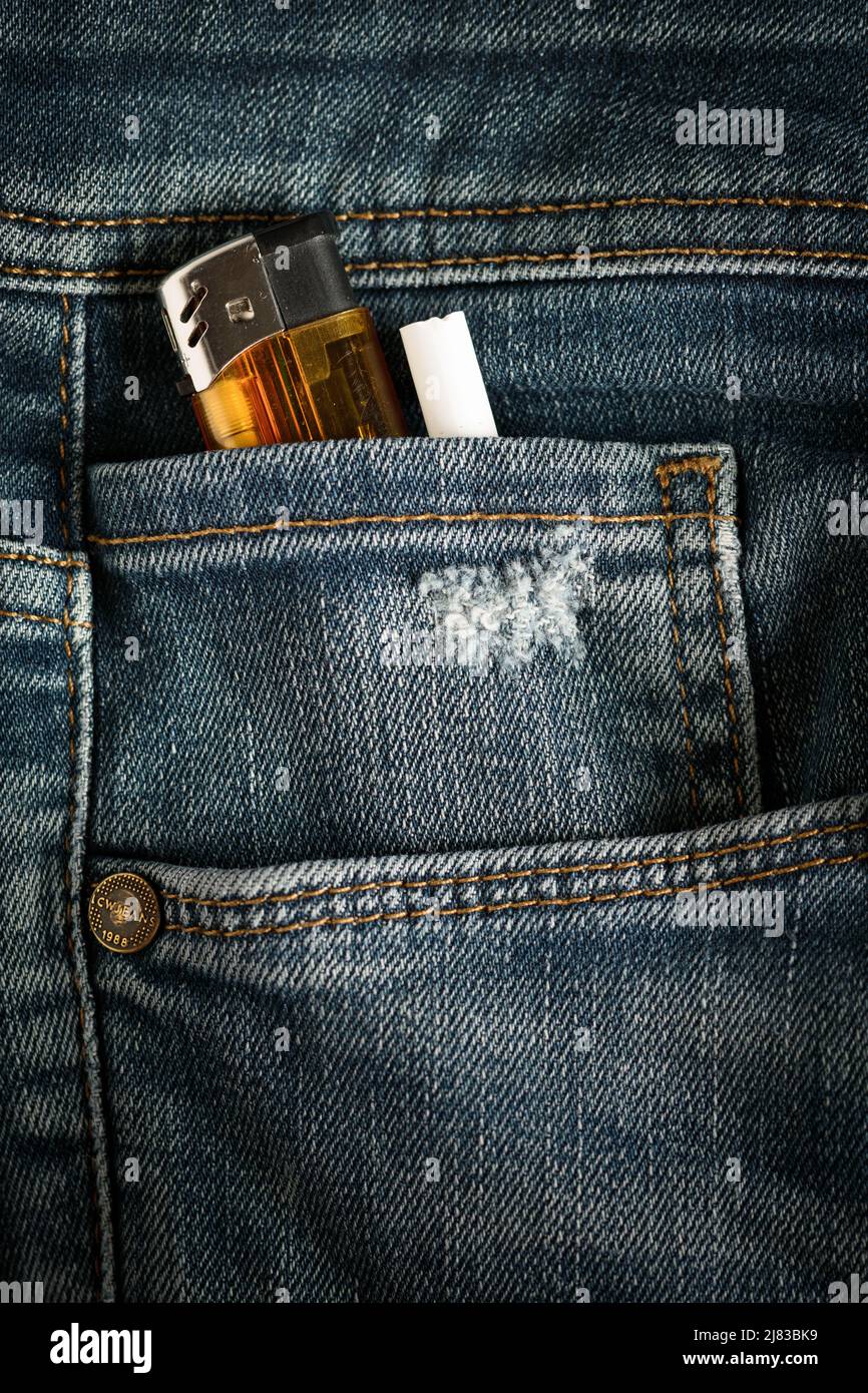 lighter and cigarette put in jeans pocket Stock Photo Alamy