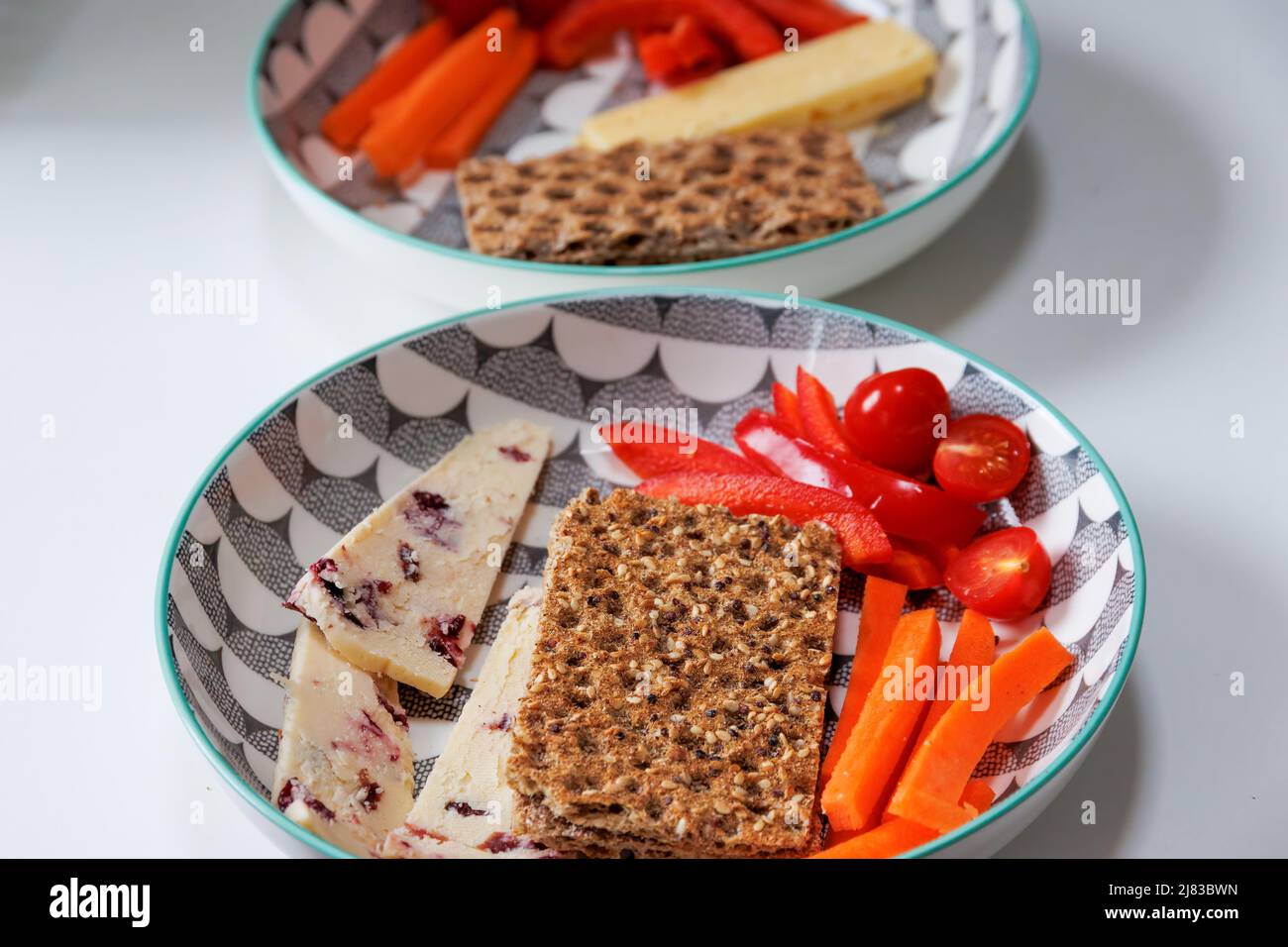 Healthy Rye crispbreads, vegetables and cheese in a bowl Stock Photo
