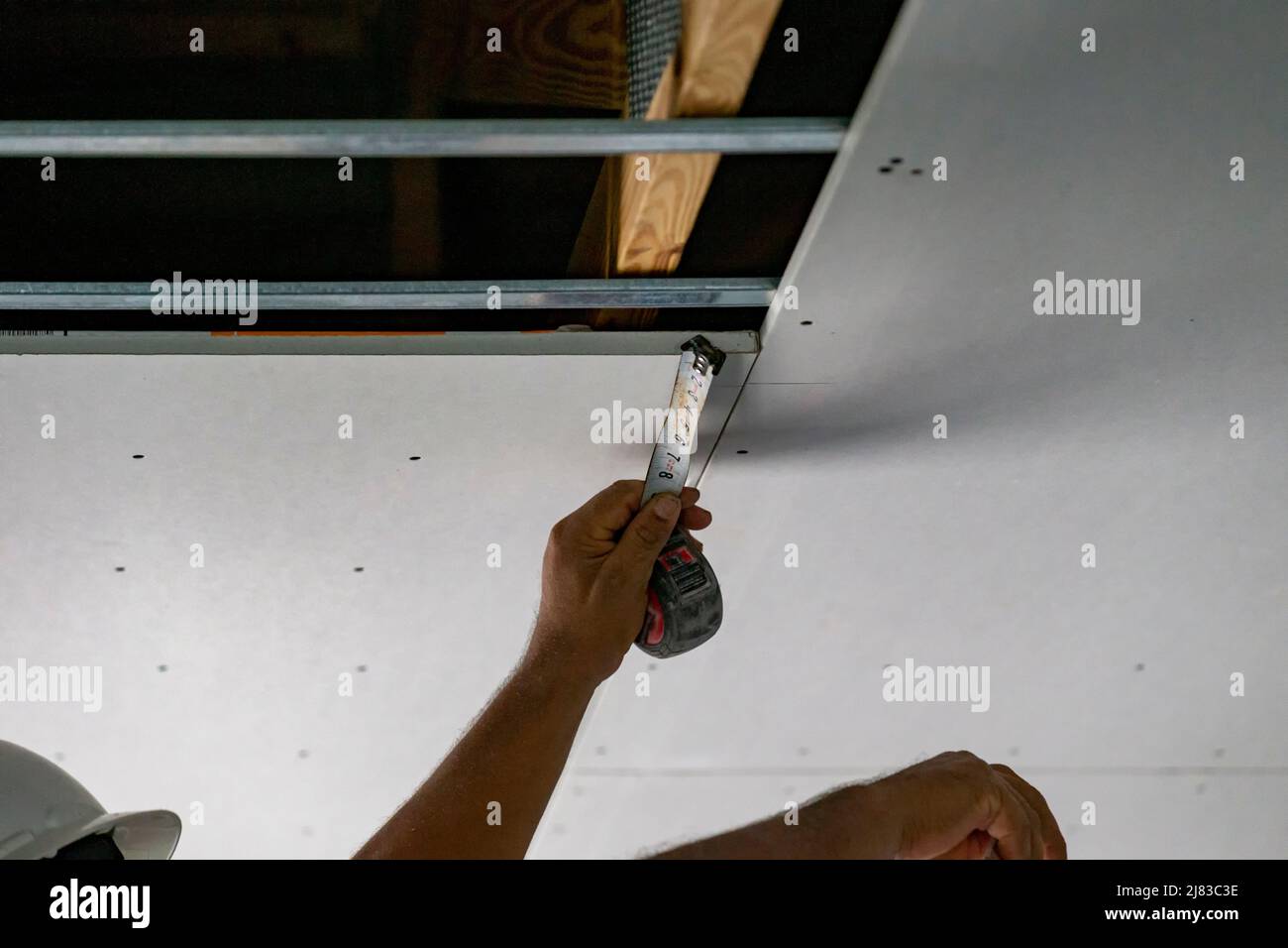 Drywall installation on ceiling. Measurements for drywall sheet Stock