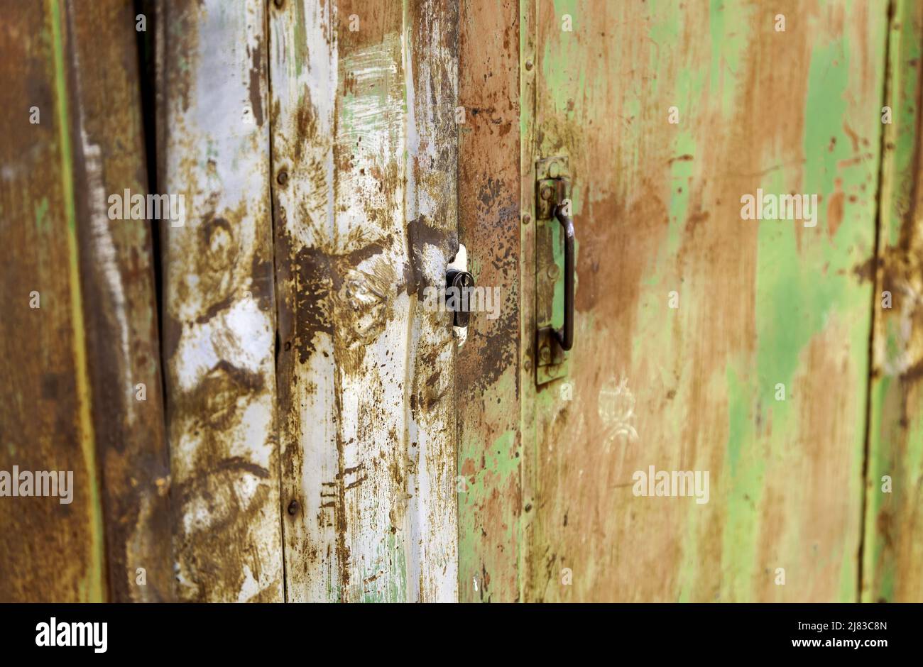 Detail of metal door damaged and rusted by the passage of time Stock