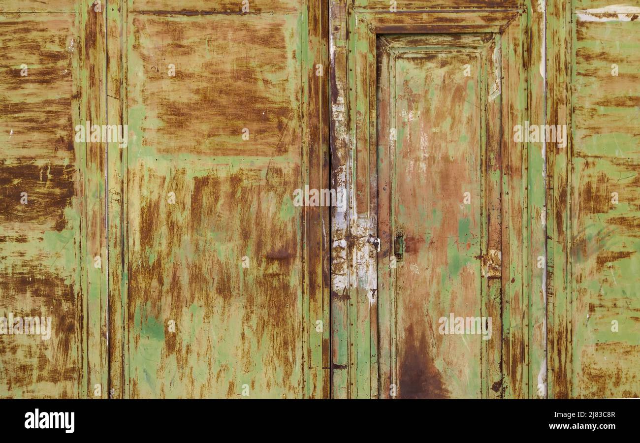 Detail of metal door damaged and rusted by the passage of time Stock