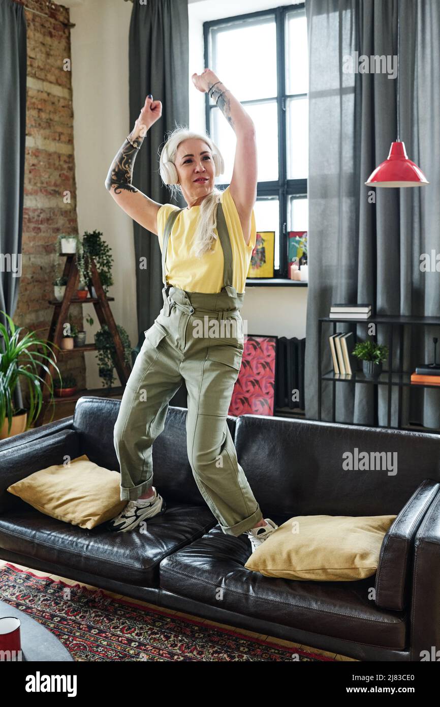 Mature woman dancing headphones hi-res stock photography and images - Alamy