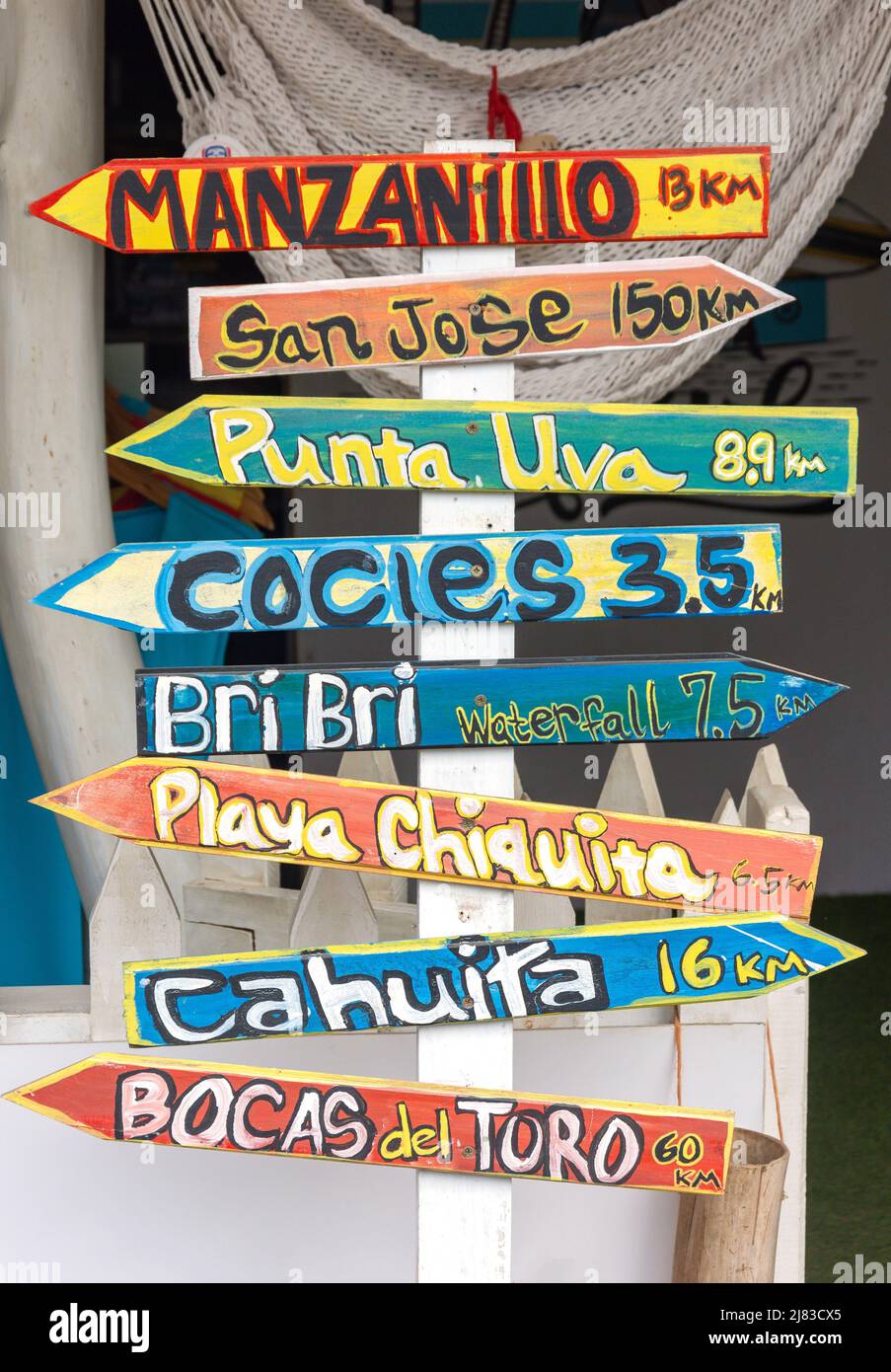 Colourful distance sign on street, C 256, Puerto Viejo de Talamanca, Limón Province, Republic of Costa Rica Stock Photo