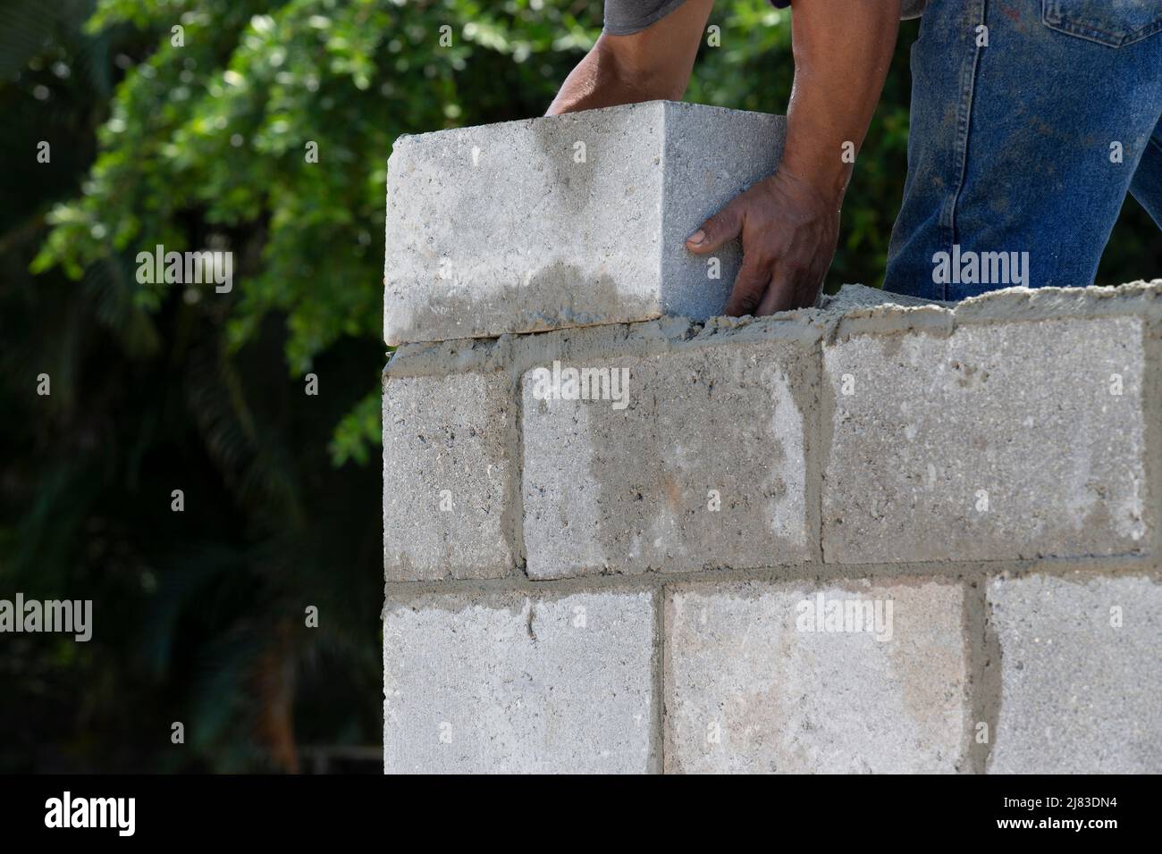 Brick Mason placing concrete brick Stock Photo Alamy